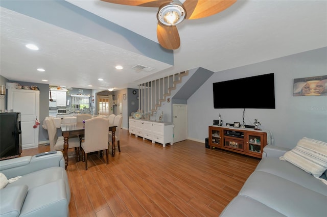 living room with ceiling fan and light wood-type flooring