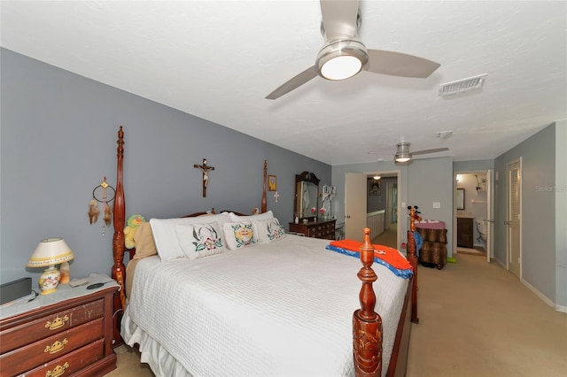 carpeted bedroom with ceiling fan and connected bathroom