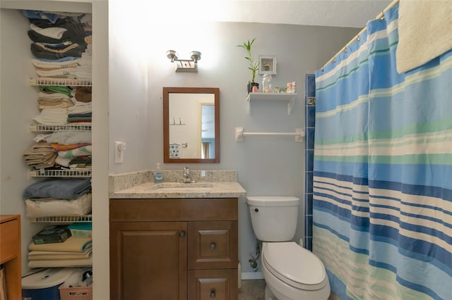 bathroom featuring vanity, curtained shower, and toilet