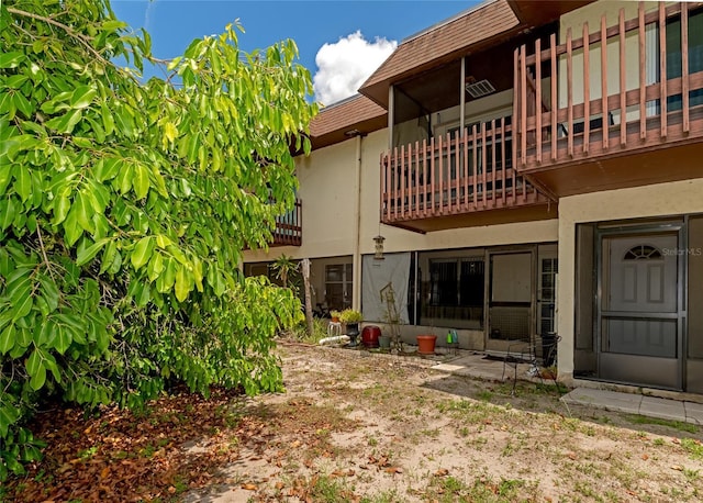 back of house featuring a balcony