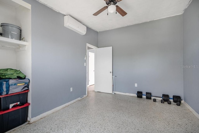 interior space featuring an AC wall unit and ceiling fan