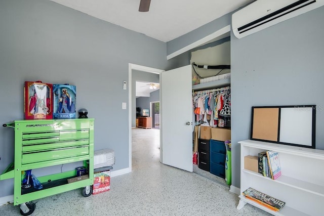 bedroom featuring an AC wall unit, ceiling fan, and a closet