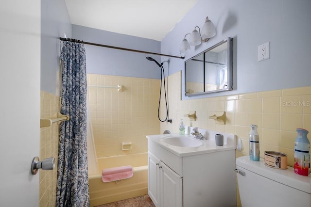 full bathroom featuring vanity, tile walls, shower / tub combo with curtain, and toilet