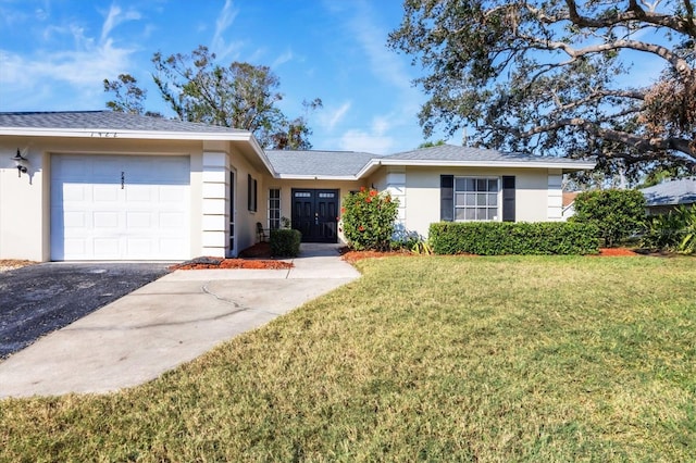 ranch-style house with a garage and a front lawn