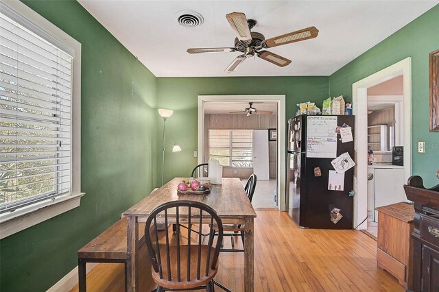 dining area with light wood-type flooring, baseboards, visible vents, and a ceiling fan