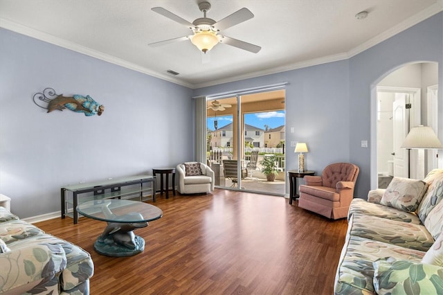 living room with visible vents, dark wood finished floors, and ornamental molding