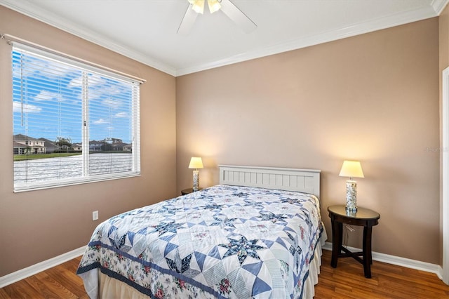 bedroom with ceiling fan, ornamental molding, wood finished floors, and baseboards