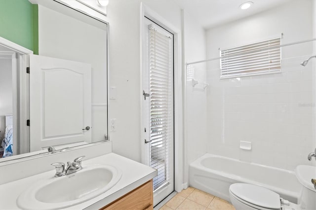 bathroom featuring toilet, shower / washtub combination, vanity, and tile patterned floors