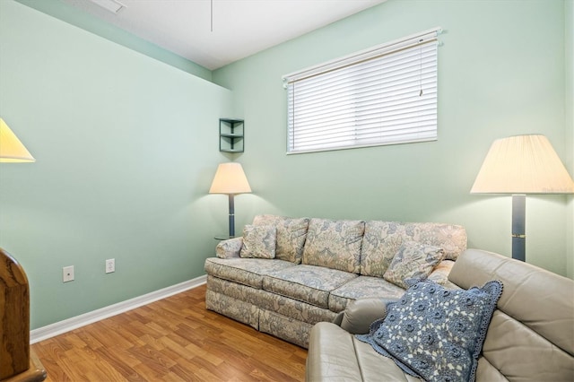 living area featuring light wood-type flooring and baseboards