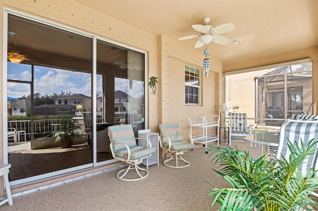 sunroom / solarium with a ceiling fan