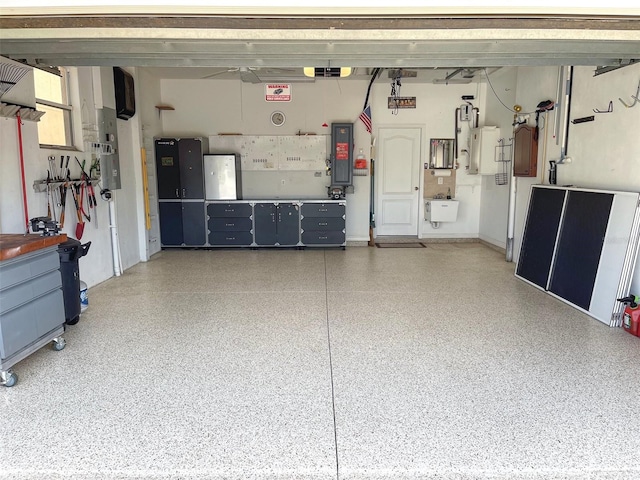 garage with a garage door opener, electric panel, and a sink