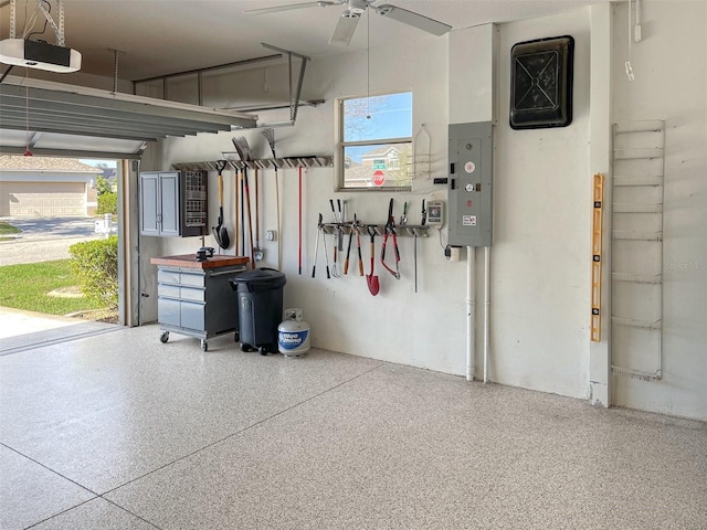 garage with ceiling fan, electric panel, and a garage door opener