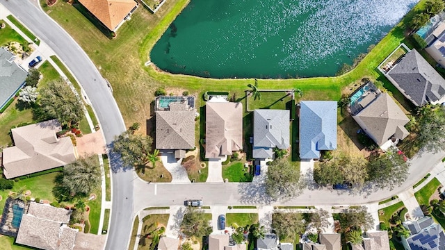 drone / aerial view featuring a residential view and a water view