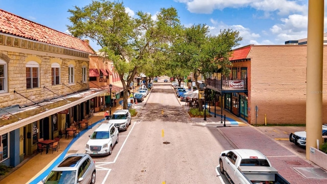 view of street with sidewalks, curbs, and street lights