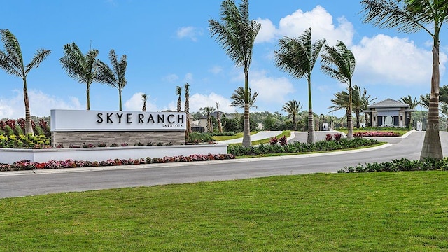 community sign featuring a lawn