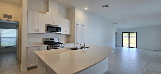 kitchen with sink, an island with sink, white cabinets, and appliances with stainless steel finishes