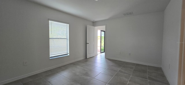 empty room featuring dark tile patterned floors