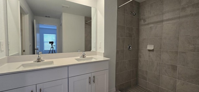 bathroom with vanity and tiled shower