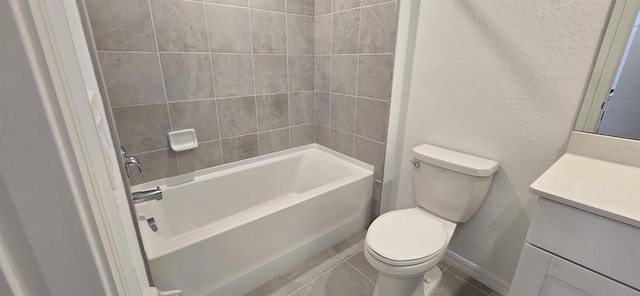 full bathroom featuring tiled shower / bath, vanity, toilet, and tile patterned flooring