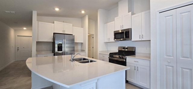 kitchen featuring white cabinetry, an island with sink, appliances with stainless steel finishes, and sink