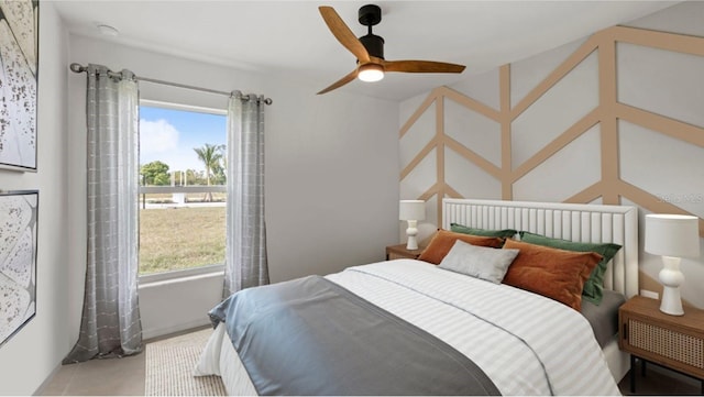 bedroom featuring multiple windows and ceiling fan