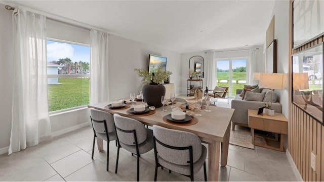 tiled dining room with vaulted ceiling