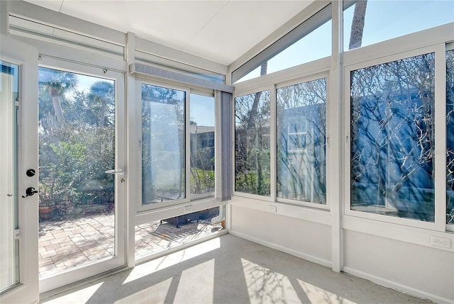 unfurnished sunroom featuring a wealth of natural light and vaulted ceiling