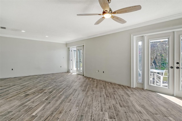 empty room with visible vents, ceiling fan, wood finished floors, crown molding, and a textured ceiling