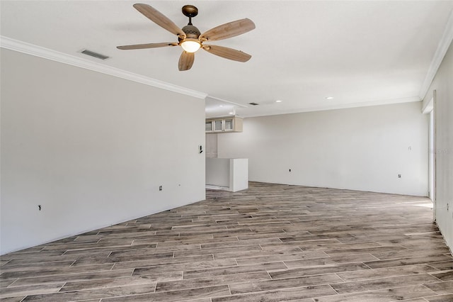 unfurnished living room with visible vents, crown molding, and wood finished floors