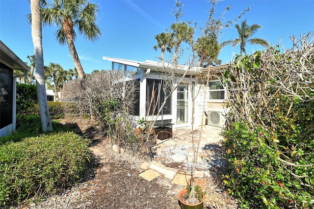 back of house featuring a sunroom