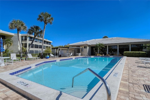 community pool featuring a patio area and fence