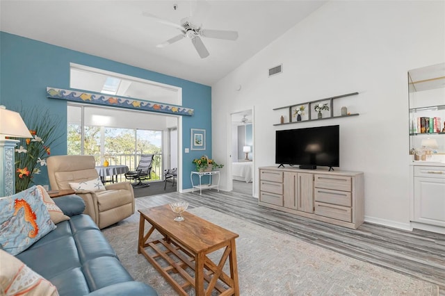 living room with high vaulted ceiling and ceiling fan