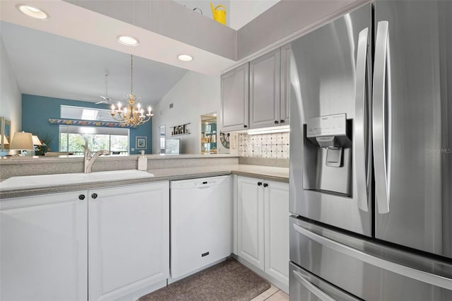 kitchen featuring white cabinetry, sink, stainless steel fridge, and white dishwasher