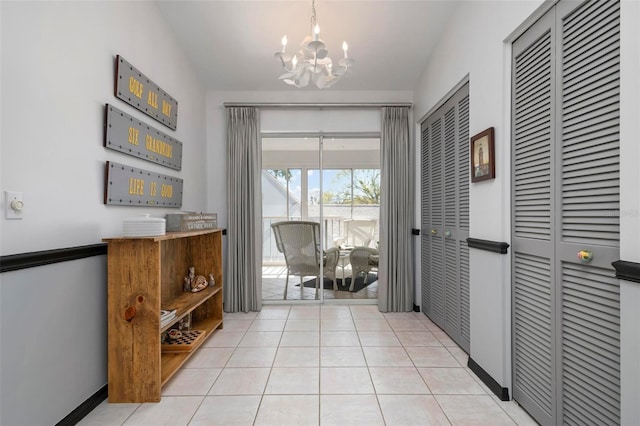 doorway featuring light tile patterned floors and a chandelier