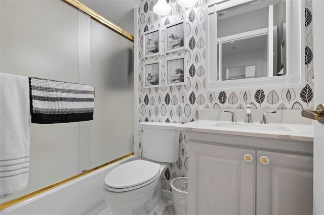 full bathroom featuring enclosed tub / shower combo, vanity, and toilet