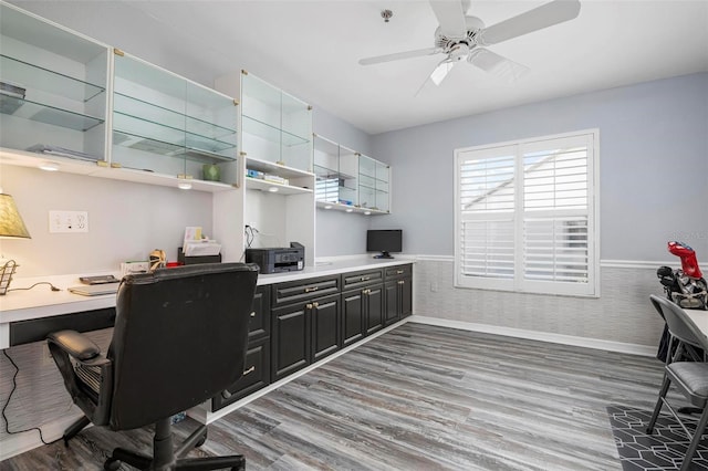 office featuring hardwood / wood-style flooring, built in desk, and ceiling fan