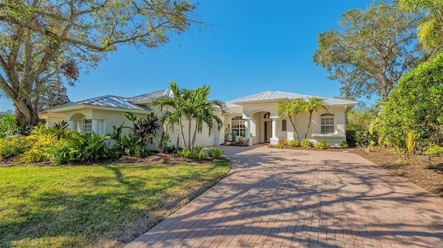 mediterranean / spanish-style home featuring a front yard