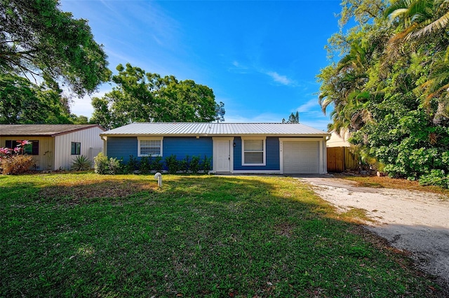 single story home with a garage and a front lawn