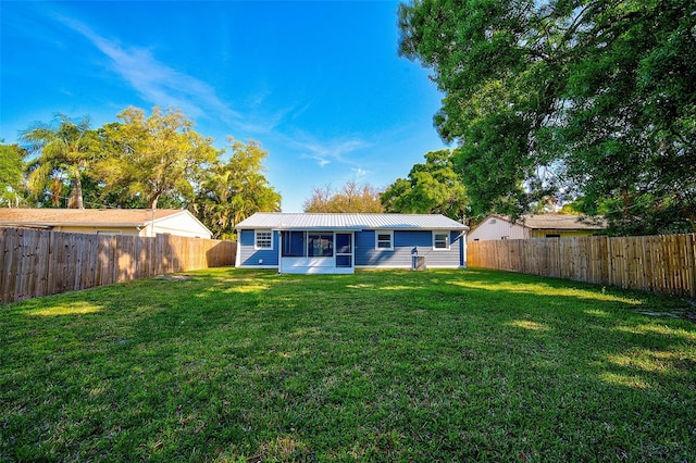 back of property with a lawn