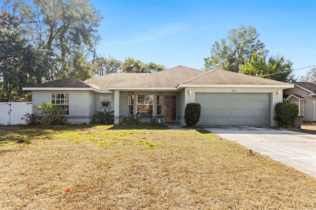 ranch-style home with a garage and a front lawn