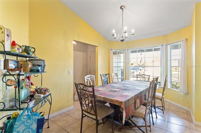 tiled dining room featuring an inviting chandelier and vaulted ceiling