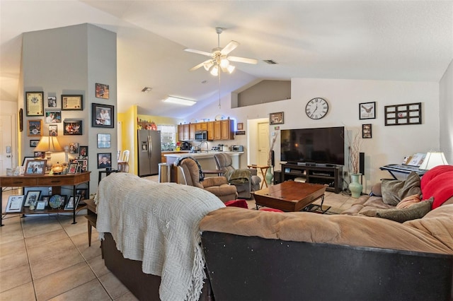 tiled living room with ceiling fan and lofted ceiling