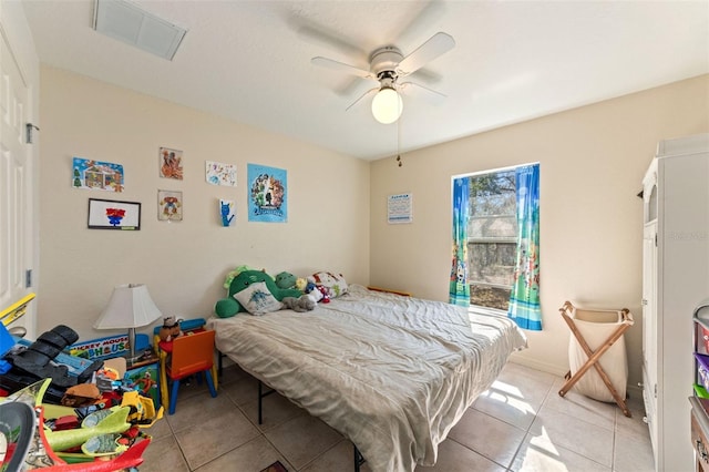 tiled bedroom featuring ceiling fan