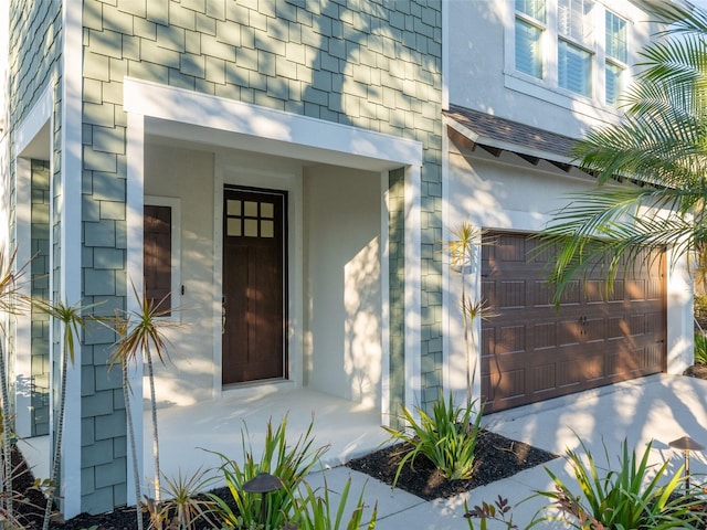 view of exterior entry with a garage