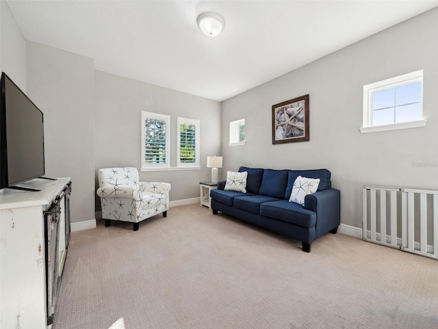 living room featuring radiator heating unit and light colored carpet