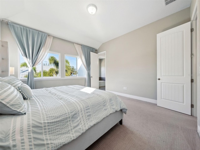 bedroom featuring vaulted ceiling and carpet floors