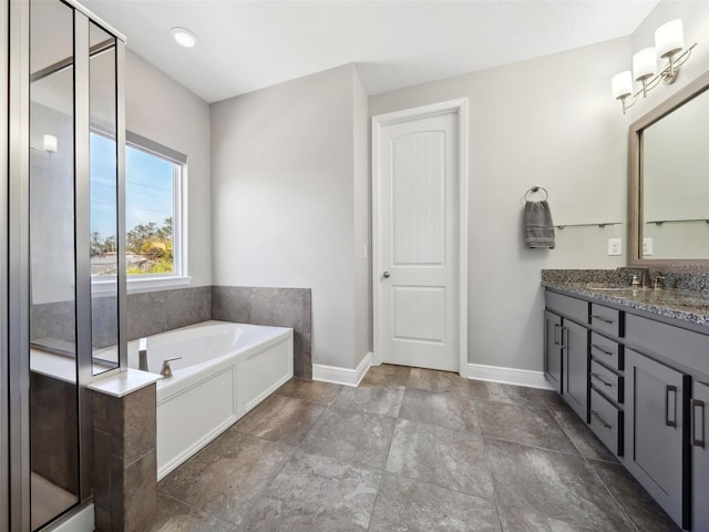 bathroom featuring vanity and a tub to relax in