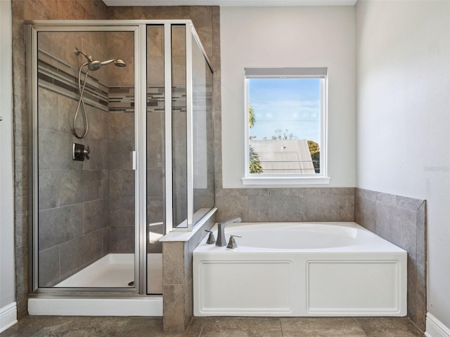 bathroom featuring separate shower and tub