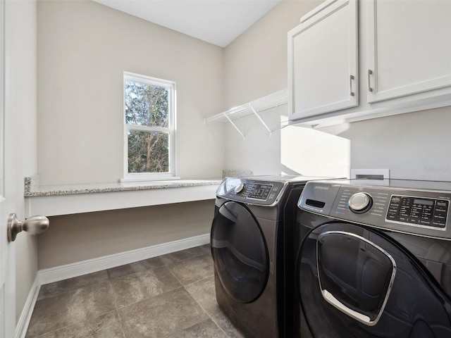 clothes washing area with cabinets and independent washer and dryer