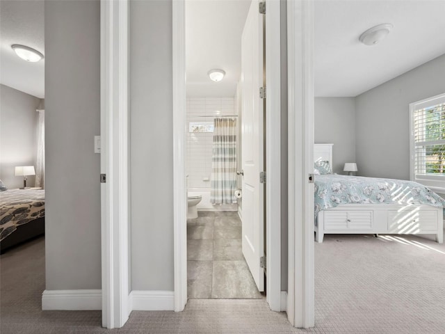 carpeted bedroom with ensuite bathroom